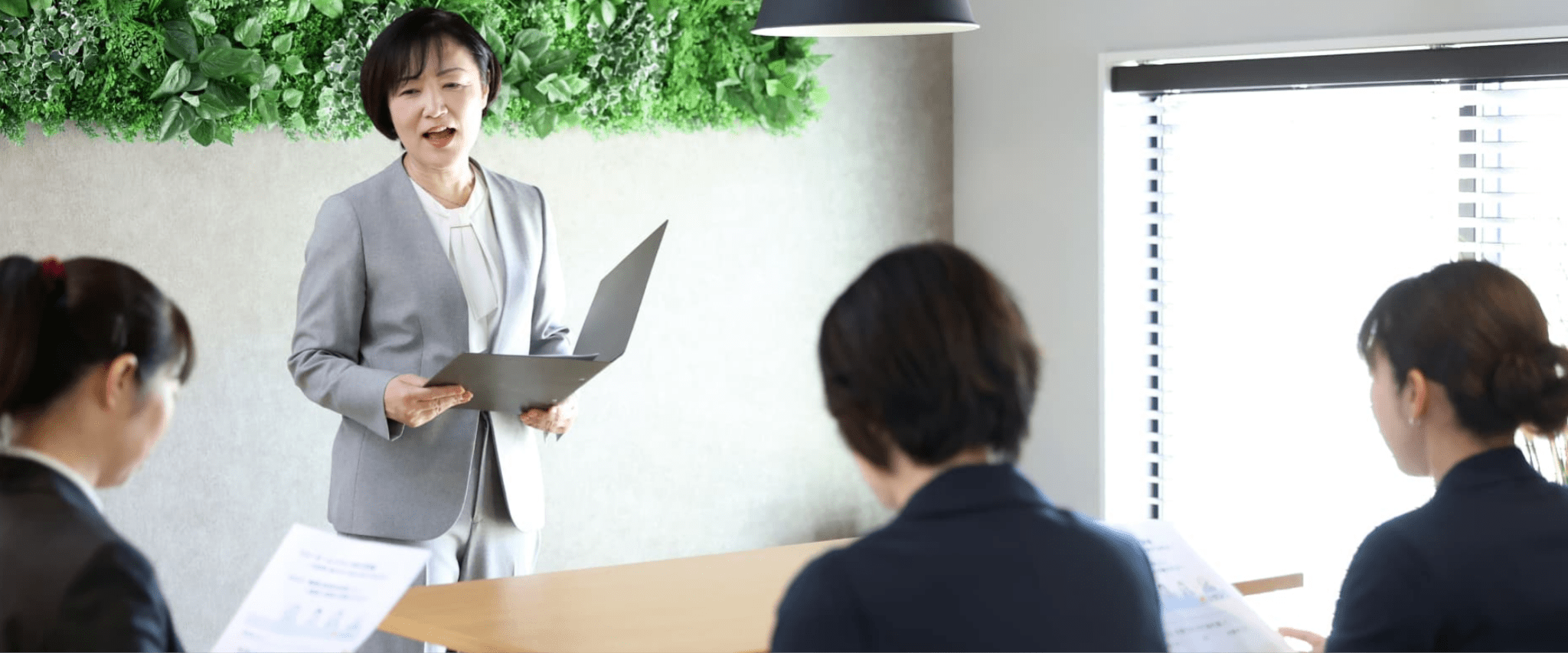 お客様に笑顔で説明する女性社員